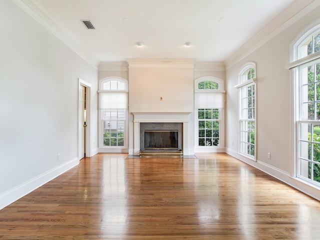unfurnished living room featuring ornamental molding, wood finished floors, a premium fireplace, and baseboards