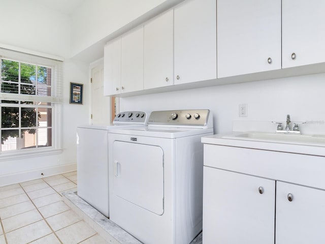 clothes washing area featuring cabinet space, independent washer and dryer, and light tile patterned flooring