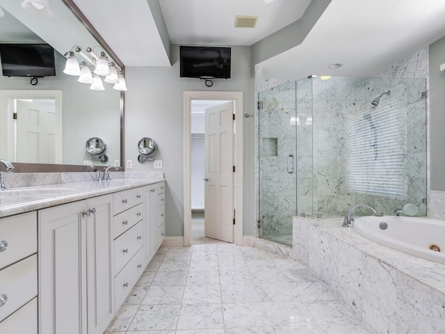 full bath with a marble finish shower, a garden tub, double vanity, marble look tile flooring, and baseboards