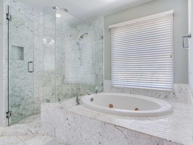 full bath with a marble finish shower and a whirlpool tub