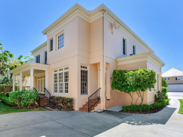 view of front of house featuring stucco siding and entry steps