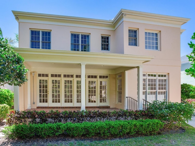 view of front facade featuring stucco siding and brick siding