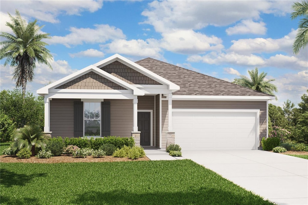 craftsman house with driveway, a front yard, and an attached garage