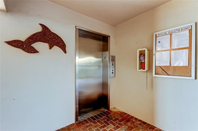 895 S Gulfview Blvd Unit 309, Clearwater Beach, FL 33767 - kitchen featuring elevator and brick floor