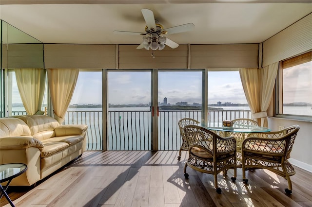 895 S Gulfview Blvd Unit 309, Clearwater Beach, FL 33767 - dining room featuring a water view, wood finished floors, and a ceiling fan