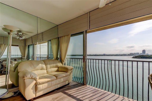 895 S Gulfview Blvd Unit 309, Clearwater Beach, FL 33767 - sunroom / solarium with wood finished floors and a water view