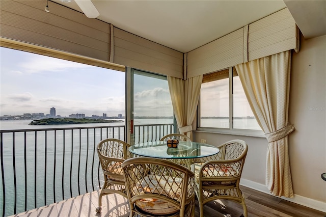 895 S Gulfview Blvd Unit 309, Clearwater Beach, FL 33767 - dining space featuring a city view, a water view, baseboards, and wood finished floors