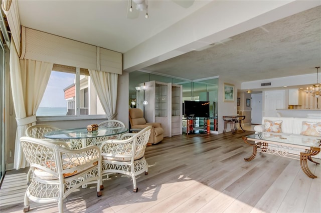 895 S Gulfview Blvd Unit 309, Clearwater Beach, FL 33767 - dining area with visible vents, ceiling fan with notable chandelier, and wood finished floors