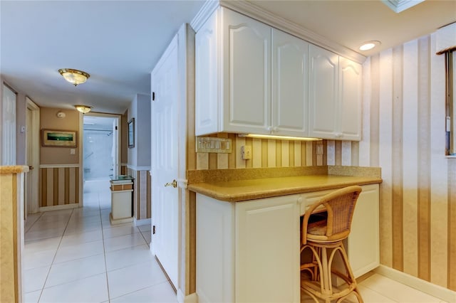 895 S Gulfview Blvd Unit 309, Clearwater Beach, FL 33767 - interior space with light tile patterned flooring, white cabinetry, wallpapered walls, and light countertops