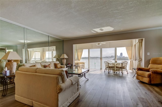895 S Gulfview Blvd Unit 309, Clearwater Beach, FL 33767 - living room featuring crown molding, a textured ceiling, and wood finished floors
