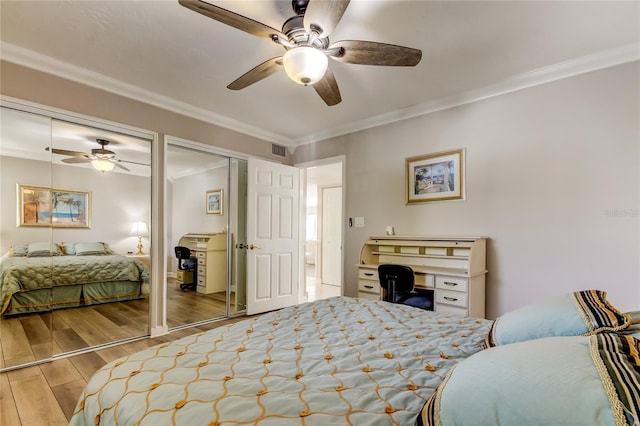 895 S Gulfview Blvd Unit 309, Clearwater Beach, FL 33767 - bedroom with crown molding, multiple closets, visible vents, a ceiling fan, and wood finished floors