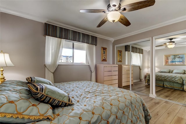 895 S Gulfview Blvd Unit 309, Clearwater Beach, FL 33767 - bedroom featuring two closets, ornamental molding, baseboards, a ceiling fan, and wood finished floors
