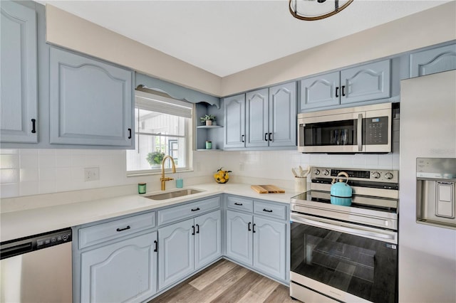 11361 88th Ave, Seminole, FL 33772 - kitchen featuring appliances with stainless steel finishes, a sink, backsplash, and light countertops