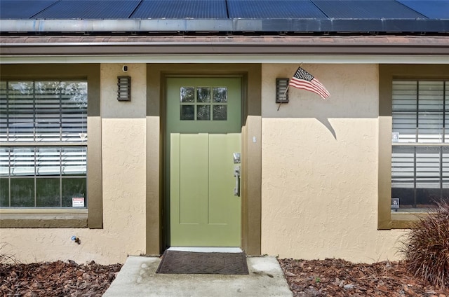 5235 Nichols Dr E, Lakeland, FL 33812 - property entrance with roof mounted solar panels and stucco siding