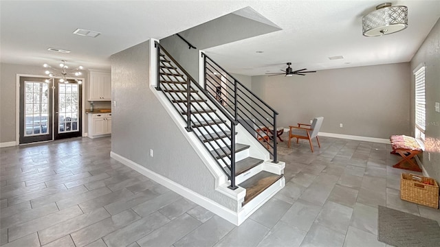 5235 Nichols Dr E, Lakeland, FL 33812 - stairway featuring baseboards, visible vents, and ceiling fan with notable chandelier