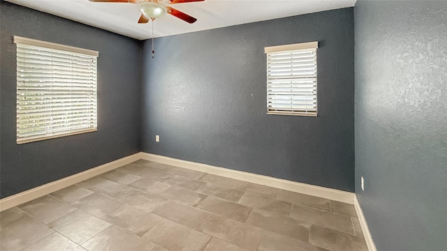 5235 Nichols Dr E, Lakeland, FL 33812 - empty room featuring plenty of natural light, a textured wall, baseboards, and ceiling fan