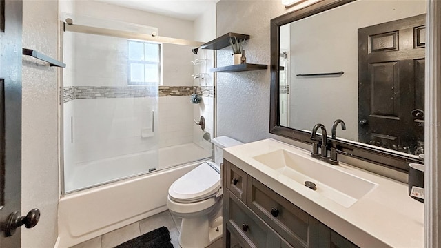 5235 Nichols Dr E, Lakeland, FL 33812 - full bath with tile patterned floors, shower / bath combination with glass door, toilet, and a textured wall