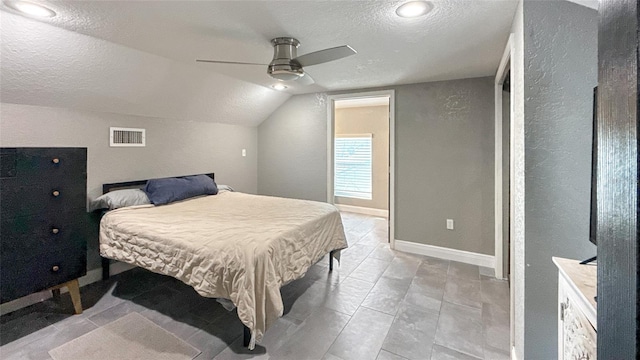 5235 Nichols Dr E, Lakeland, FL 33812 - bedroom with lofted ceiling, baseboards, a textured ceiling, ceiling fan, and visible vents