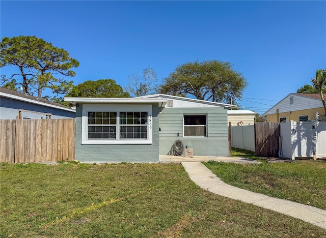 bungalow with fence and a front yard