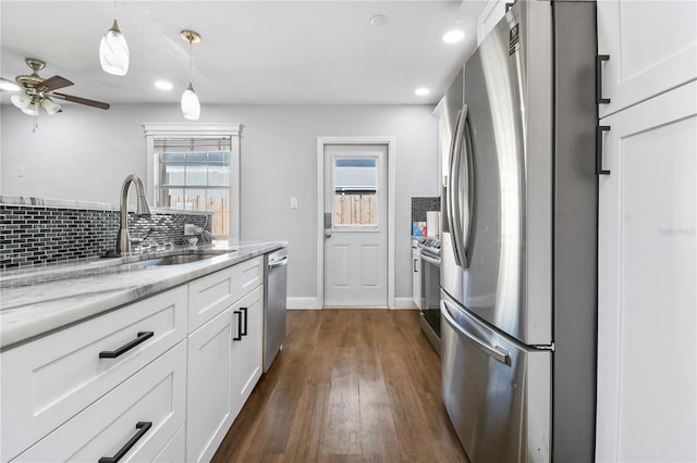 kitchen with backsplash, a ceiling fan, white cabinetry, appliances with stainless steel finishes, and plenty of natural light