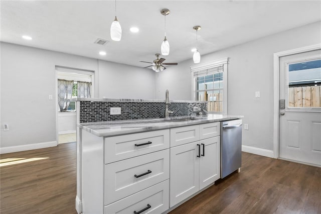 kitchen featuring dark wood-style floors, white cabinets, a wealth of natural light, and dishwasher