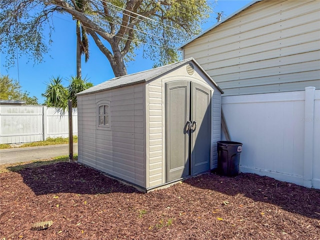 view of shed with fence