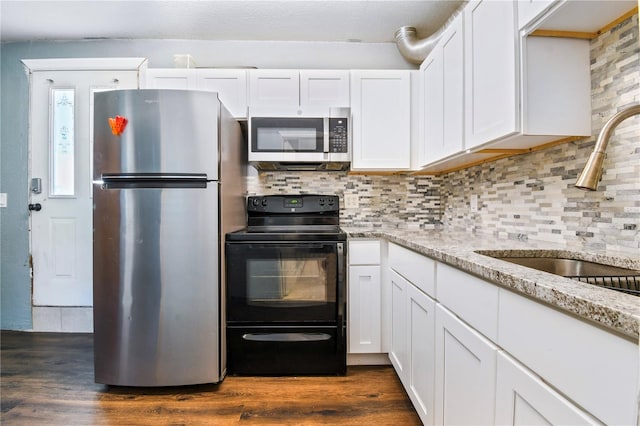 kitchen featuring backsplash, a sink, appliances with stainless steel finishes, and dark wood finished floors