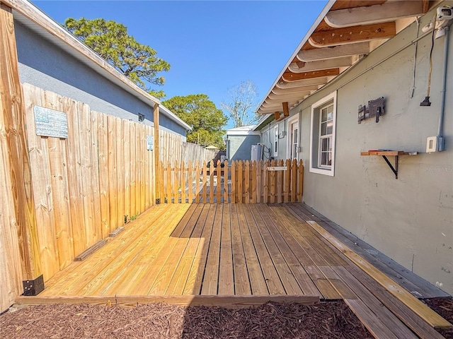 wooden terrace featuring fence