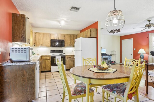 kitchen with light countertops, a ceiling fan, light tile patterned floors, white appliances, and visible vents