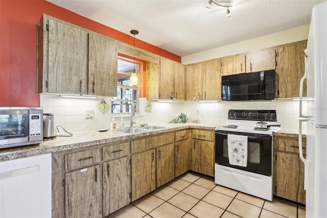 kitchen featuring decorative backsplash, a sink, light tile patterned flooring, range with electric stovetop, and black microwave