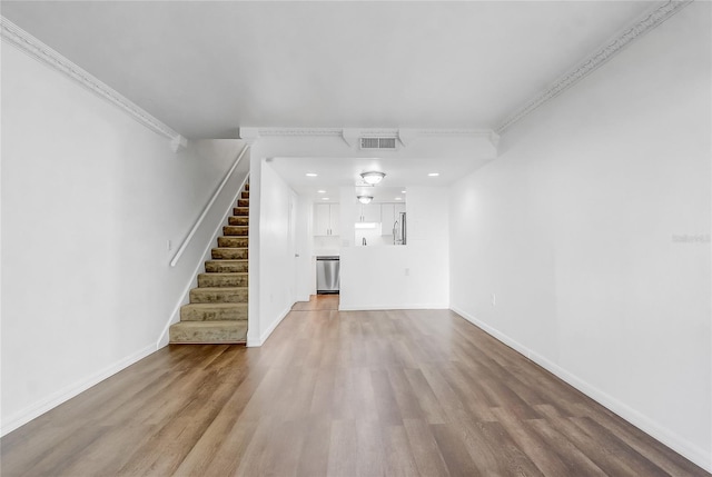 4215 S Semoran Blvd Unit 3, Orlando, FL 32822 - unfurnished living room with wood finished floors, stairs, ornamental molding, and recessed lighting