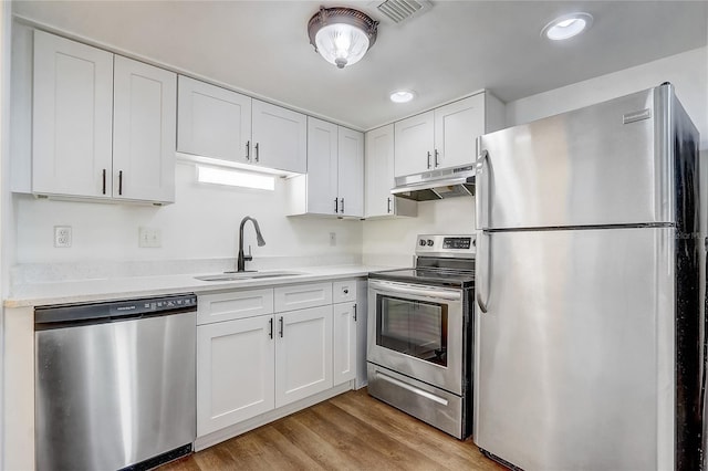 4215 S Semoran Blvd Unit 3, Orlando, FL 32822 - kitchen featuring stainless steel appliances, under cabinet range hood, white cabinetry, light countertops, and recessed lighting