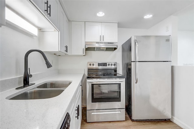 4215 S Semoran Blvd Unit 3, Orlando, FL 32822 - kitchen with stainless steel appliances, under cabinet range hood, white cabinetry, light wood-style flooring, and light stone counters