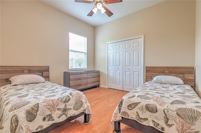 bedroom with ceiling fan, baseboards, wood finished floors, and a closet