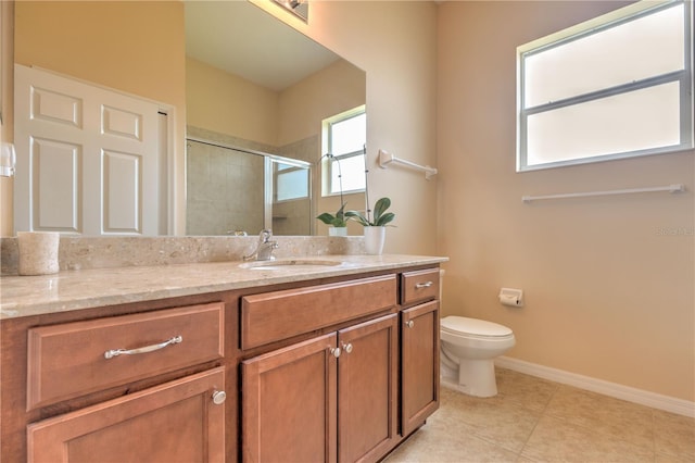 full bathroom featuring toilet, a stall shower, baseboards, tile patterned flooring, and vanity