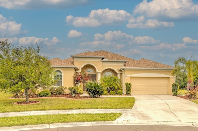 2218 132nd Pl E, Parrish, FL 34219 - mediterranean / spanish house with a front yard, an attached garage, stucco siding, and driveway