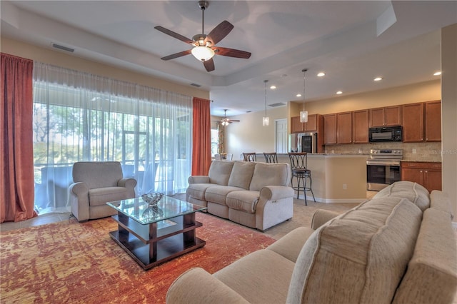 2218 132nd Pl E, Parrish, FL 34219 - living room featuring a tray ceiling, ceiling fan, visible vents, and recessed lighting