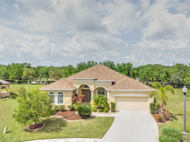 2218 132nd Pl E, Parrish, FL 34219 - mediterranean / spanish house featuring a front yard, stucco siding, and a garage