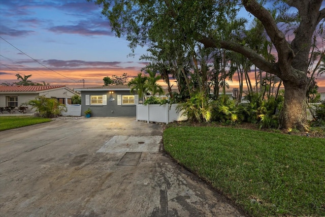 7912 3rd Ave S, Saint Petersburg, FL 33707 - view of front of house with concrete driveway, a lawn, and stucco siding