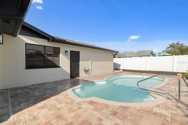 view of pool with a patio area, a fenced in pool, and fence