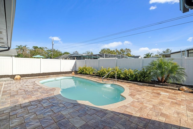 view of swimming pool featuring a patio and a fenced backyard