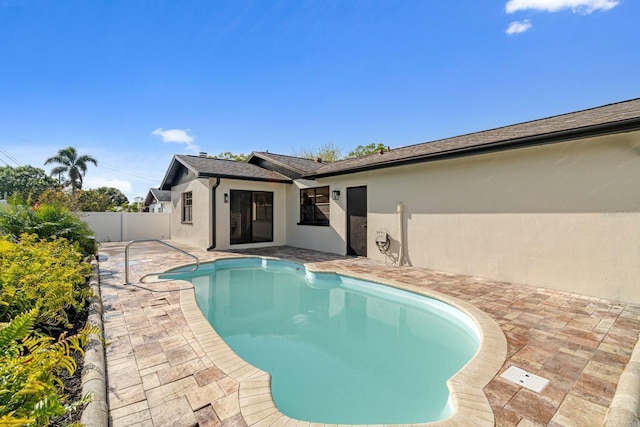 view of swimming pool featuring a patio area and fence