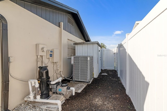 view of home's exterior featuring central AC and fence