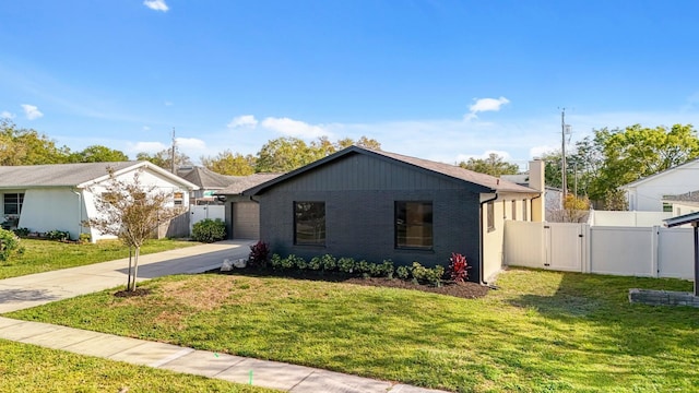 view of front of property with a gate, concrete driveway, a garage, and brick siding
