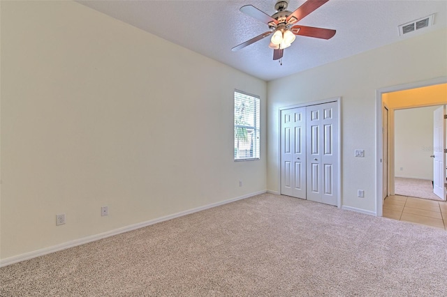 5409 Conch Shell Pl, Apollo Beach, FL 33572 - unfurnished bedroom with a ceiling fan, a closet, visible vents, baseboards, and light colored carpet