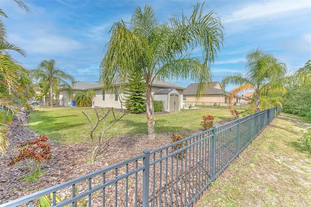 5409 Conch Shell Pl, Apollo Beach, FL 33572 - view of yard featuring a storage unit, an outdoor structure, and fence