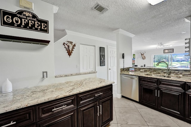 kitchen with visible vents, dishwasher, light stone countertops, a sink, and light tile patterned floors
