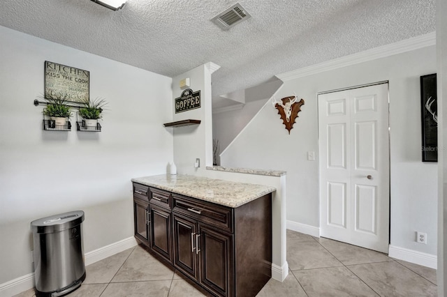 kitchen featuring light tile patterned floors, dark brown cabinets, open shelves, and visible vents