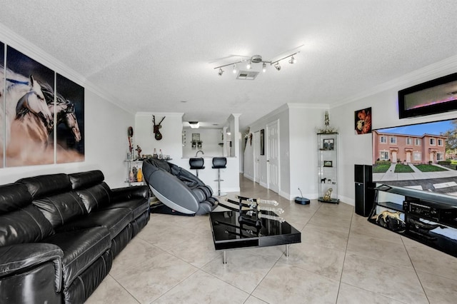workout area featuring tile patterned floors, ornamental molding, and a textured ceiling