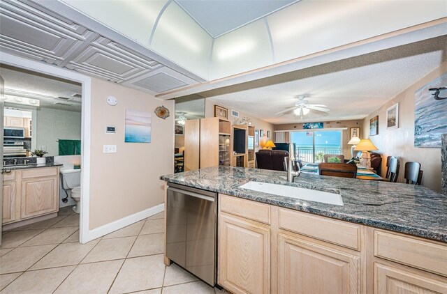 13000 Gulf Blvd Unit 109, Madeira Beach, FL 33708 - kitchen featuring light tile patterned floors, a sink, stainless steel appliances, open floor plan, and light brown cabinets
